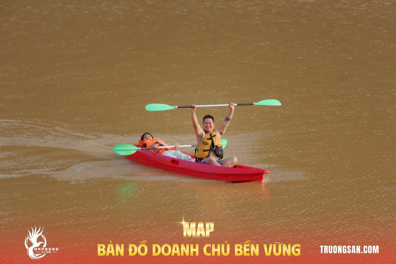 Học viên MAP CAMP mùa 19 giơ cao mái chèo trên thuyền kayak giữa hồ