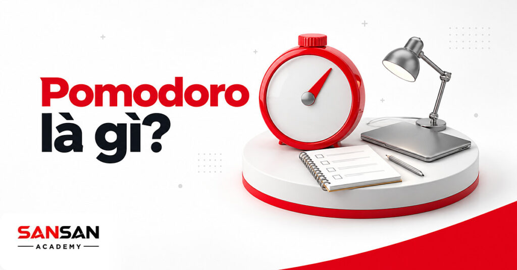 Đồng hồ hẹn giờ tròn trắng đỏ cạnh sổ ghi nhiệm vụ, bút chì và laptop minh họa phương pháp Pomodoro